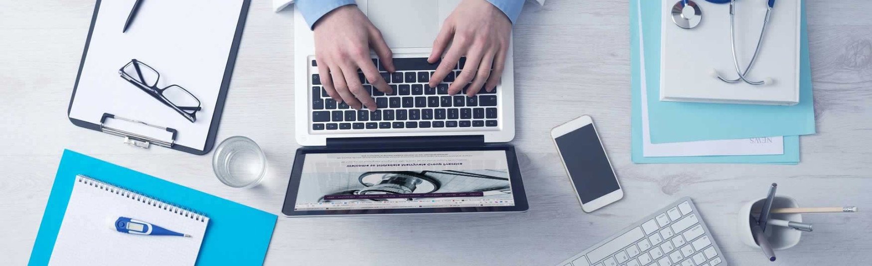 Doctor viewing patient medical records on laptop